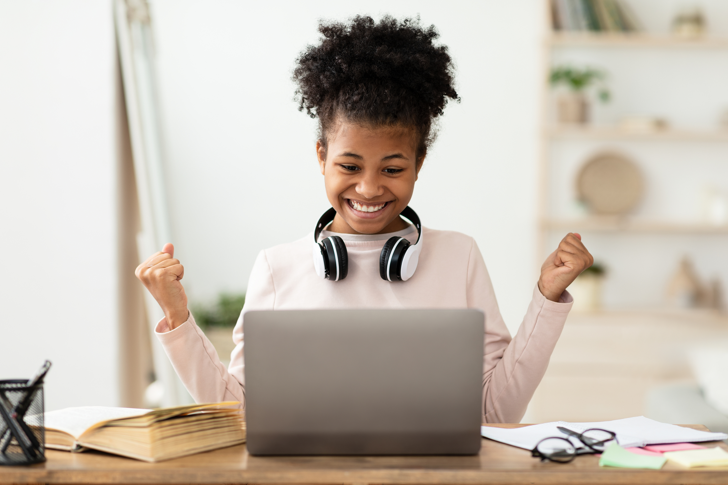 excited girl at laptop gesturing